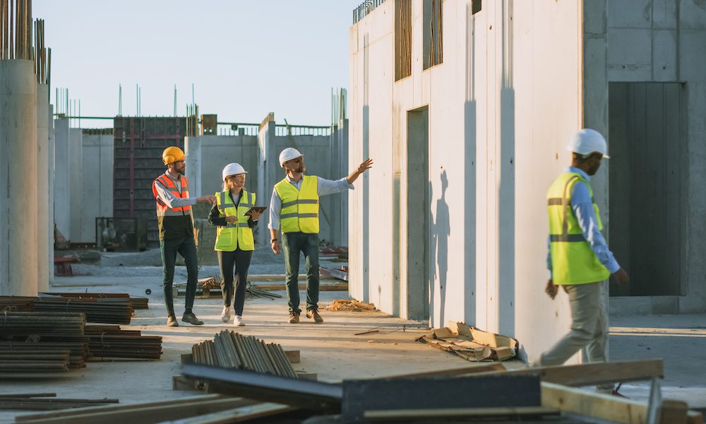 The Importance of Requiring Contractors to Have Primary Non-Contributory Insurance in CGL Policies/ A Must for Property Managers, Building Owners, and Coops - Contractors walking on a job site