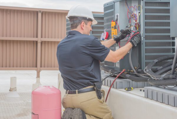 Protecting Your HVAC Business/ The Importance of a Pollution Liability Policy - Man working on a HVAC System