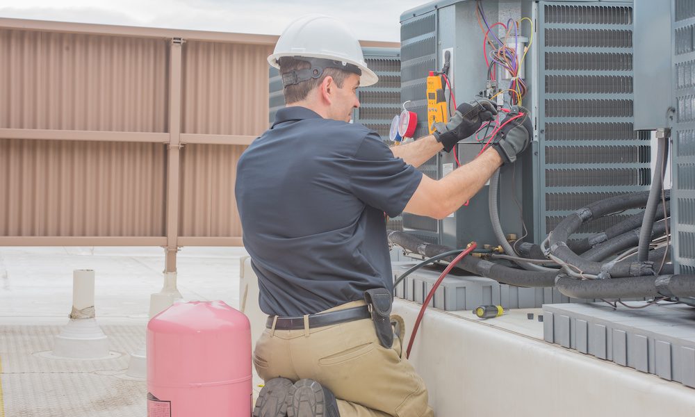 Protecting Your HVAC Business/ The Importance of a Pollution Liability Policy - Man working on a HVAC System