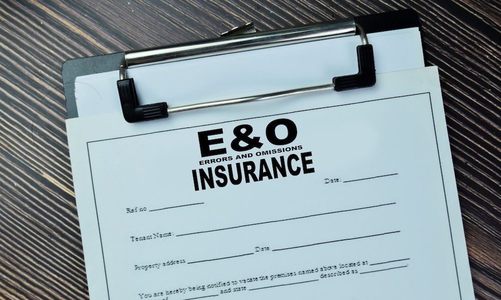 The Importance of E&O Insurance for General Contractors - Clipboard on a desk with an E&O Insurance Document