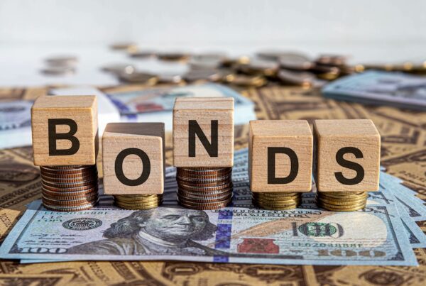 What Documents Are Needed to Apply for a Performance and Payment Bond? - Bonds spelled out in blocks stacked on money