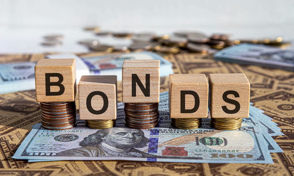 What Documents Are Needed to Apply for a Performance and Payment Bond? - Bonds spelled out in blocks stacked on money
